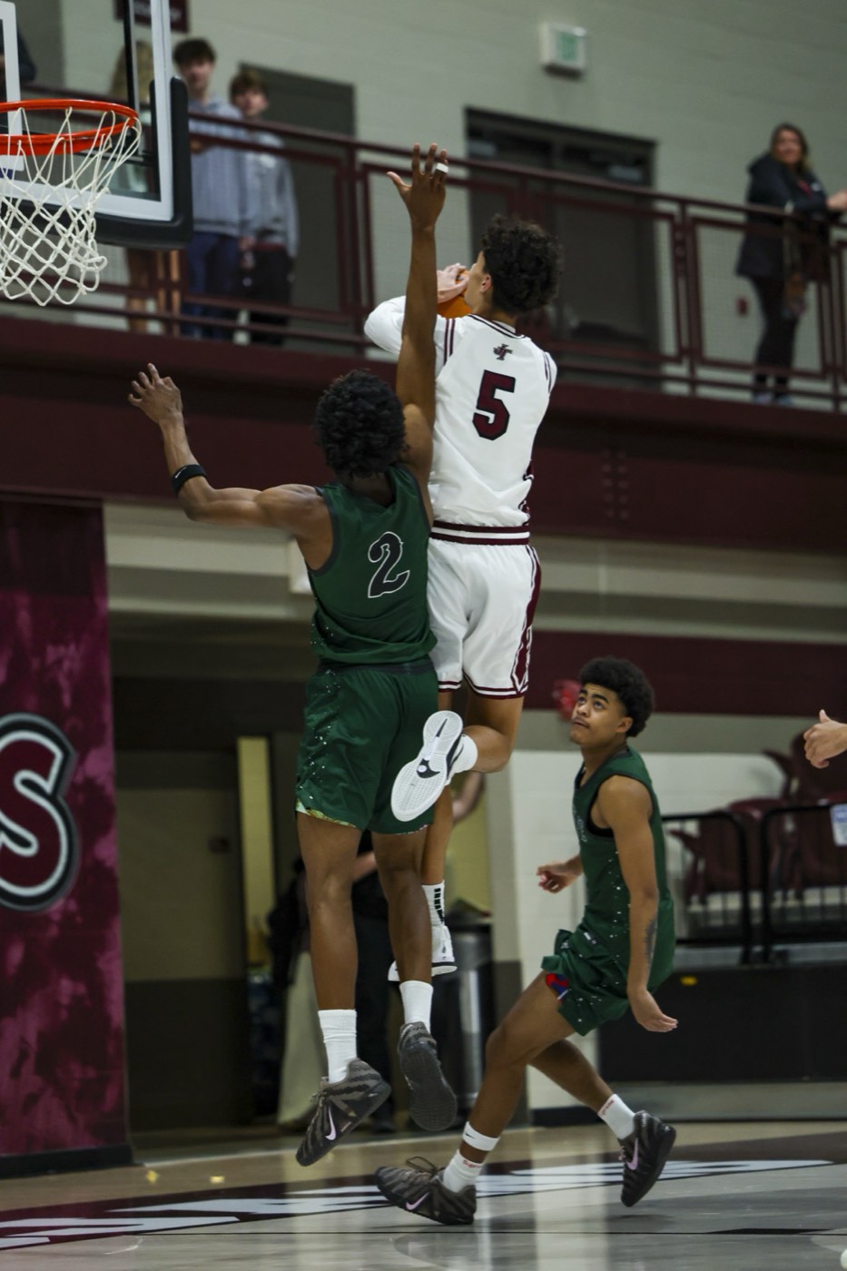 Aiden Bezenah finishing an and-one at the rim